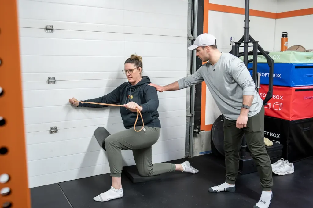 Kamloops personal trainer coaching a client through banded strength work to hold new range of motion