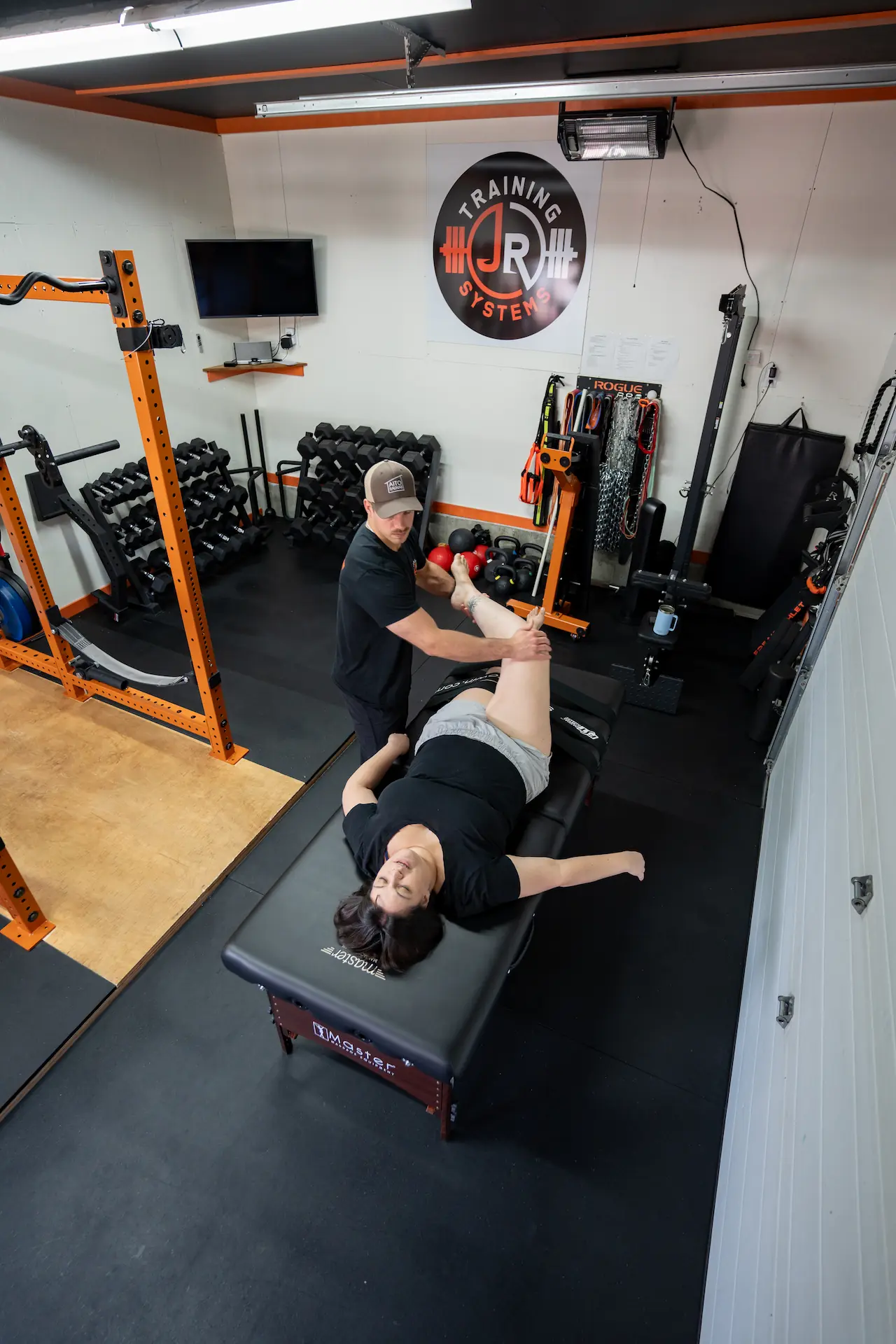 Jake guiding a client through an assisted fascia stretch therapy session on the table