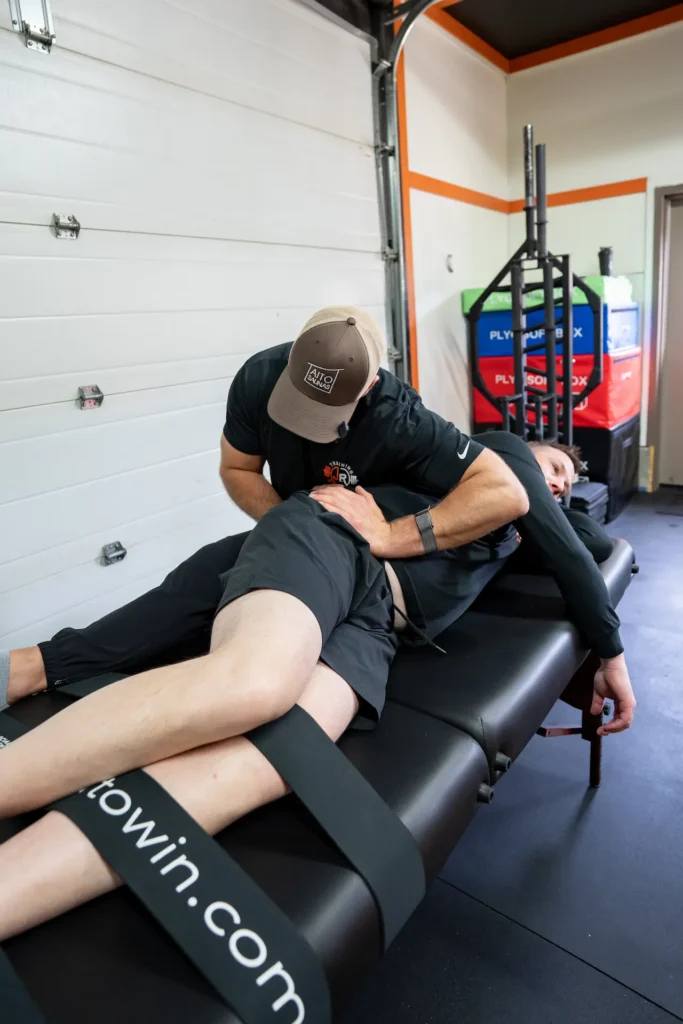 Kamloops trainer performing a fascia stretch therapy shoulder stretch on a client at JR Training Systems